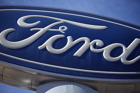 The Ford company logo is seen, Oct. 24, 2021, on a sign at a Ford dealership in southeast Denver.