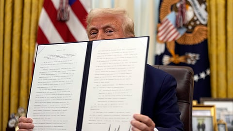 US President Donald Trump holds a signed an executive order regarding the declassification and release of records relating to the assassinations of former President John F. Kennedy, Sen. Robert F. Kennedy and Rev. Martin Luther King, Jr., in the Oval Office of the White House, Thursday, Jan. 23, 2025, in Washington.