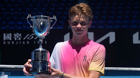 Henry Bernet of Switzerland holds his trophy after defeating Benjamin Willwerth of the U.S. in the boy's singles final at the Australian Open tennis championship in Melbourne, Australia, Saturday, Jan. 25, 2025.
