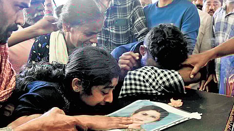 Radha’s daughter Aneesha and son Anil crying over her coffin