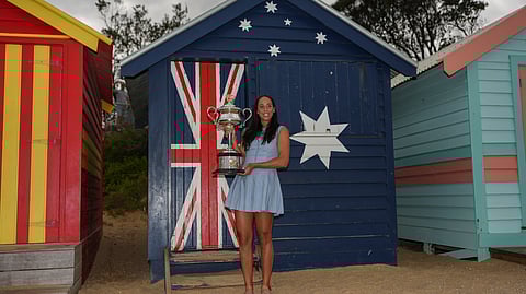 Madison Keys of the U.S. holds the Daphne Akhurst Memorial Cup at the Brighton Beach Boxes the morning after defeating Aryna Sabalenka of Belarus in the women's singles final at the Australian Open tennis championship in Melbourne, Australia, Sunday, Jan. 26, 2025.