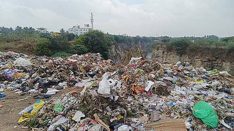 An abandoned quarry is turned into an open dumpsite at Madukkarai