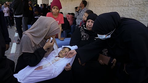 A mother cries for her daughter, who was killed in the Israeli bombardment of the Gaza Strip in Deir al-Balah, Sunday, Dec. 3, 2023.
