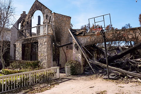 A basketball is stuck in the net outside of a residence destroyed by the Palisades Fire in the Pacific Palisades neighbourhood of Los Angeles, Friday, Jan. 24, 2025.