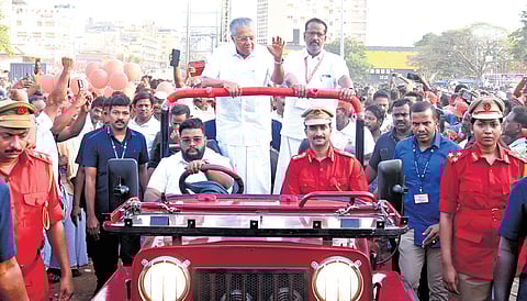 Chief Minister Pinarayi Vijayan greets party workers as he arrives to inaugurate the valedictory session of CPM district conference at Marine Drive on Monday