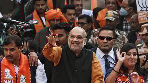Union Home Minister and BJP leader Amit Shah with party MP Bansuri Swaraj during a roadshow in support of party candidate Neeraj Basoya ahead of Delhi Assembly elections, in New Delhi, Tuesday, Jan. 28, 2025.