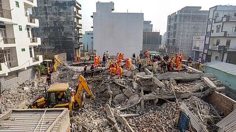 Rescue work underway after a four-storey building collapsed, at Burari area, in New Delhi.