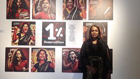 Artist Kalki Subramaniam poses before her paintings at Durbar Hall, Kochi