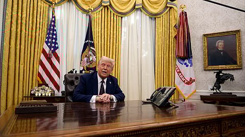 US President Donald Trump answers questions from reporters as he signs an executive orders in the Oval Office of the White House, Jan. 23, 2025, in Washington.