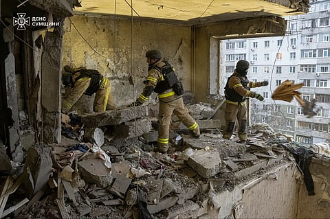 In this photo provided by the Ukrainian Emergency Service, rescuers search for civilians who were killed when a Russian drone hit an apartment building in Sumy, Ukraine, Thursday, Jan. 30, 2025.