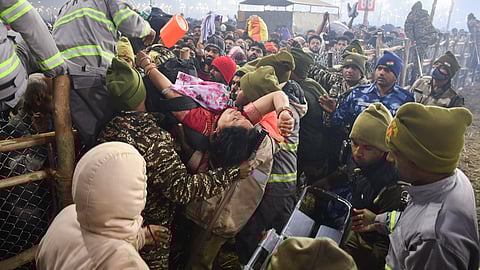 Security and UP Fire and Emergency Services personnel rescue a woman during a stampede-like situation on 'Mauni Amavasya', at the ongoing Maha Kumbh Mela, in Prayagraj.