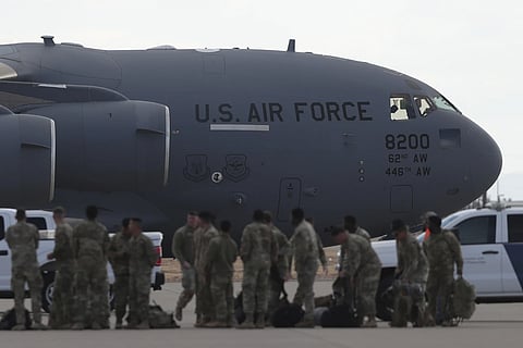 A US military aircraft carrying migrants to be deported to Guatemala is ready for takeoff as soldiers stand on the tarmac at Fort Bliss in El Paso, Tx, Thursday, January 30, 2025.