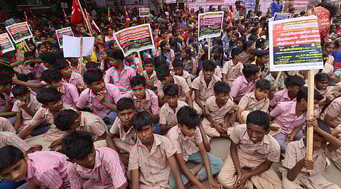 Members of Tamil Nadu Kattunaiyakar Association staging a protest along with their children for demanding to issue community certificates to their children in Madurai