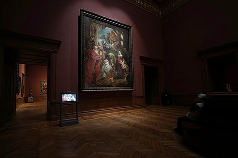 A visitor looks at 'The Adoration of the Magi', painted by Flemish artist Peter Paul Rubens.