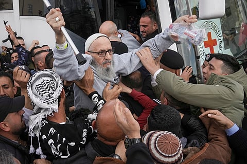 Palestinian prisoners as greeted as they exit a Red Cross bus after being released from Israeli prison following a ceasefire agreement between Israel and Hamas, in the West Bank city of Ramallah, Saturday Feb. 1, 2025.