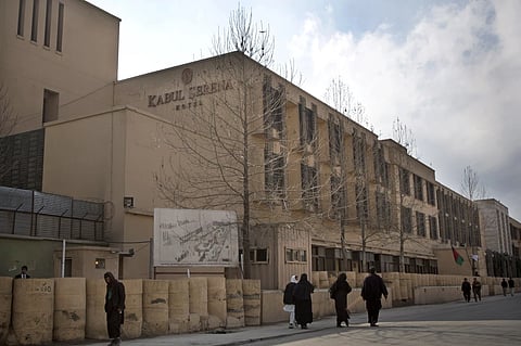 Afghans walk by the Serena hotel in downtown Kabul, Afghanistan, March 21, 2014.