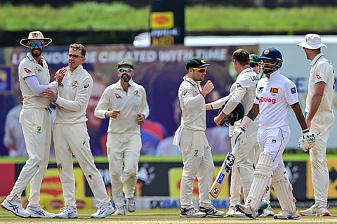 Australia's Todd Murphy (2L) celebrates with teammates after taking the wicket of Sri Lanka's Dimuth Karunaratne (2R) during the fourth day of the first Test cricket match between Sri Lanka and Australia at the Galle International Cricket Stadium in Galle on February 1, 2025
