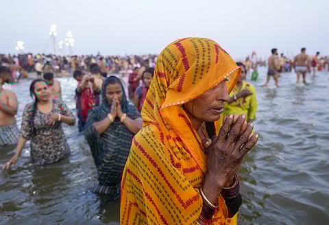 Devotees pray while taking a holy dip in the Ganga river on the eve of the 'Basant Panchami Amrit Snan' during the Maha Kumbh Mela 2025.