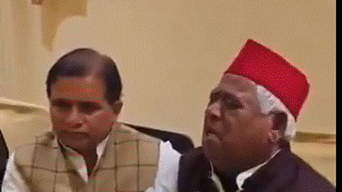 Faizabad MP crying during a press meet and others beside him consoling him.