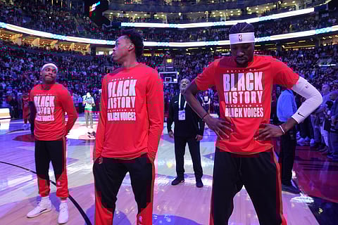 From left to right, Toronto Raptors forwards Bruce Brown, Scottie Barnes and Chris Boucher react as fans boo the United States national anthem before NBA basketball game action against the Los Angeles Clippers in Toronto, Sunday, Feb. 2, 2025.