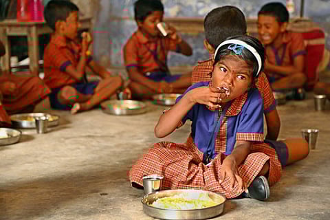 Students are seen eating lunch in a government school in Chennai