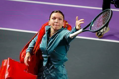 Romania's Simona Halep throws her racket into the tribune after announcing her retirement from professional tennis following a defeat at the Transylvania Open women's tennis tournament, Tuesday, Feb. 4, 2025, in Cluj, Romania.