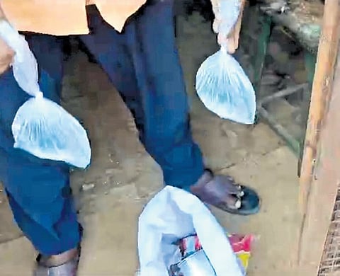 Screengrab of the video showing the man with the packets of illicit liquor