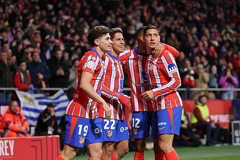 Atletico Madrid's Argentine forward #22 Giuliano Simeone celebrates with teammates after scoring the opening goal during the Spanish Copa del Rey quarter-final first leg football match between Club Atletico de Madrid and Getafe CF on February 4, 2025.