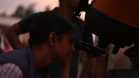 School students trying to spot planets through a telescope at a sky-watch event organised by IISER’s outreach wing