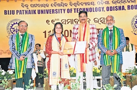 A student is being awarded a certificate at the convocation ceremony.