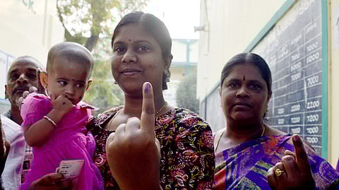 People displays their imked finger after cast their vote for Erode East constituency by-election at CSI school in Erode on Wednesday