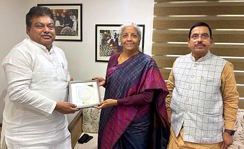 Karnataka Minister for Large and Medium Industries MB Patil invites Union Finance Minister Nirmala Sitharaman for Global Investors Meet to be held in Bengaluru, in New Delhi on Wednesday. Union Minister Pralhad Joshi is also seen.