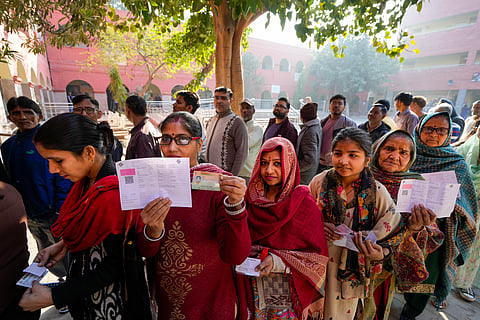 People wait in queues to cast their votes at a polling booth during the Delhi Assembly elections, at Trilokpuri, in New Delhi, Wednesday, Feb. 5, 2025.