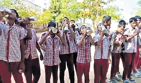 Students of ZPHS Jillela drink water at the school playground in Rajanna Sircilla district