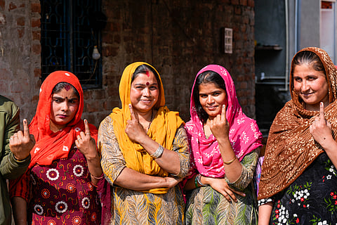 Pakistani Hindu refugees show their fingers marked with indelible ink after casting their votes for the first time during the Delhi Assembly elections, at resettlement colony in Majnu Ka Tila area, in New Delhi, Wednesday, Feb. 5, 2025.