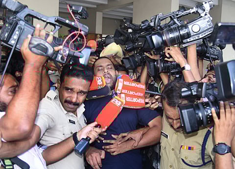 Police accompany Anandhu Krishnan, the accused in the half-price scam, to Ashoka Flats near the High Court in Kochi for evidence collection on February 9 (Photo | Express)