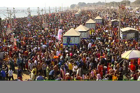 Devotees arrive to take a holy dip during the ongoing Mahakumbh Mela, in Prayagraj, Saturday, Feb. 8, 2025.