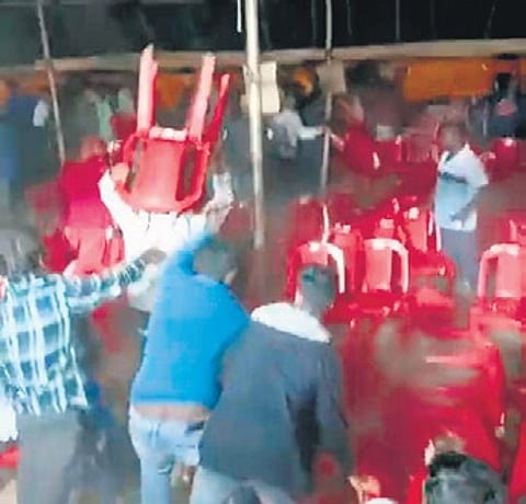 Video grab of people hurling chairs during the Jatra on Sunday evening
