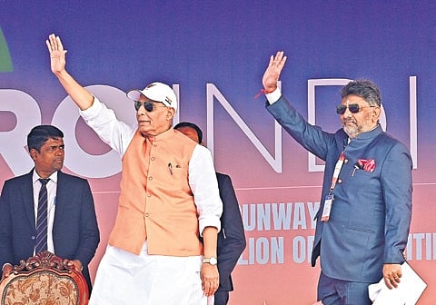 Defence Minister Rajnath Singh and DyCM DK Shivakumar greet the gathering at Aero India in Bengaluru on Monday