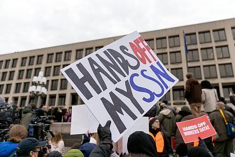 People protest during a rally against Elon Musk outside the U.S. Department of Labor in Washington, Wednesday, Feb. 5, 2025.