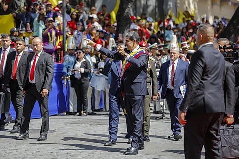 Venezuelan President Nicolas Maduro greets government supporters after being sworn in for a third term in Caracas, Venezuela, Friday, Jan. 10, 2025.