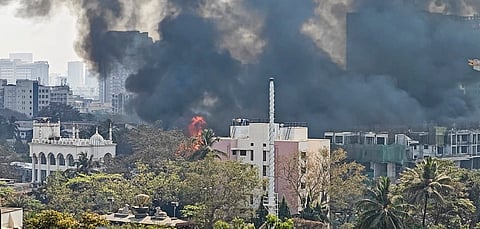 Thick smoke rises after a fire broke out at the Oshiwara furniture market, in Mumbai, Tuesday,