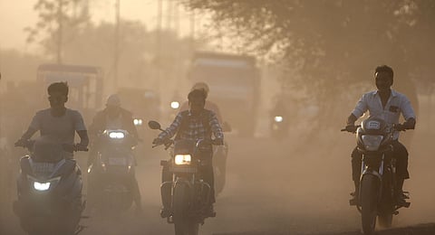 Dust rises as commuters drive past a road in Ahmedabad, India, on Feb. 5, 2025.