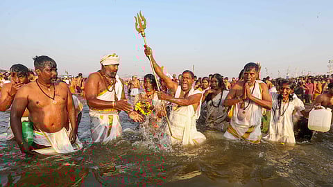 Devotees take a holy dip at the Sangam on Maghi Purnima, during the ongoing Maha Kumbh Mela 2025