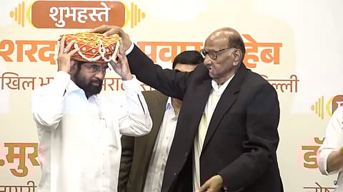 Sharad Pawar honouring Maharashtra Deputy Chief Minister Eknath Shinde.