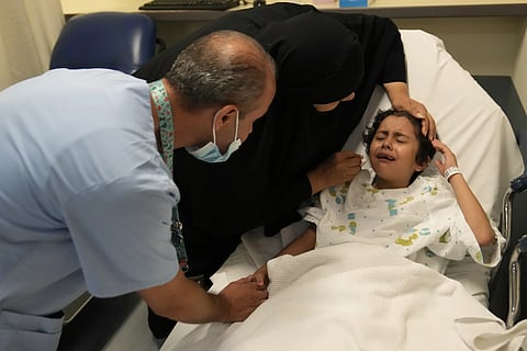Palestinian girl Halima Abou Yassine, 7, who was brought to Lebanon from Gaza for treatment after an Israeli strike left her near death with a gaping wound in her skull, cries as she lies in a hospital bed ahead of a surgery on her head at the American University of Beirut Medical Center, Monday, July 15, 2024.
