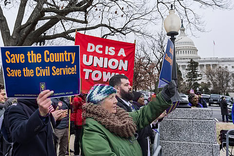 Civil service workers and activists protest the policies of President Donald Trump and Elon Musk outside the Capitol in Washington, Tuesday, Feb. 11, 2025.