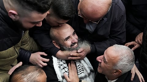 Palestinian prisoner Waddeh Bazrah, 43, is greeted after being released from Israeli prison following a ceasefire agreement between Israel and Hamas, in the West Bank city of Ramallah.