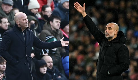 Liverpool manager Arne Scot (L) and Manchester City's manager Pep Guardiola