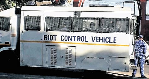 A riot-control vehicle stands at a gate of Jamia Millia campus on Thursday